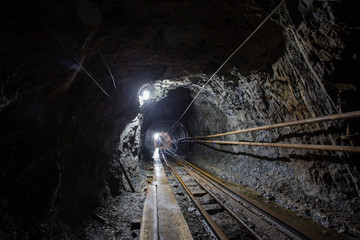 Naklejka premium Gold mine ore shaft tunnel with rails