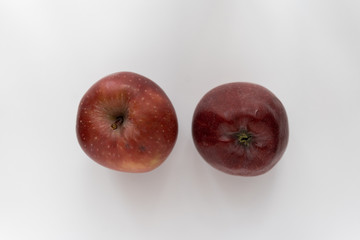 two red apples on a white background