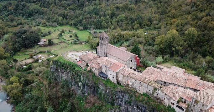 Aerial view of Castellfollit de la Roca, medieval Catalan hamlet on cliff on autumn day