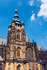 Fototapeta premium Prague, bell gothic towers and St. Vitus Cathedral. St. Vitus is a Roman Catholic cathedral in Prague, Czech Republic. Panoramic view from the courtyard to the south facade. Prague, Czechia.