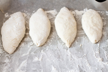 pies on a baking sheet with flour