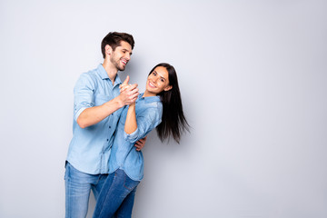 Profile side view portrait of his he her she nice attractive charming lovely adorable cheerful cheery positive tender couple wearing casual dancing isolated on light white gray pastel color background