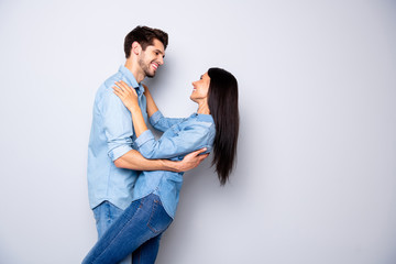 Obraz premium Profile side view portrait of his he her she nice attractive charming lovely careful cheerful cheery couple wearing casual embracing dancing isolated over light white gray pastel color background