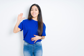 Beautiful brunette woman over isolated background Waiving saying hello happy and smiling, friendly welcome gesture