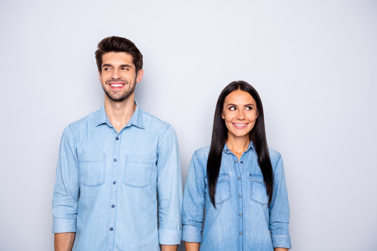 Photo of cute cheerful brown haired charming couple of spouses feeling awkward smiling toothily wearing jeans denim isolated over grey color background