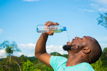 man drinking water from bottle © wazkkii