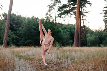 girl dancing in the summer in a pine forest