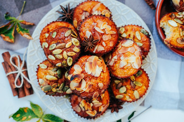 Healthy fall vegetarian dessert. Apple cupcake with pumpkin, almond seeds and spices.