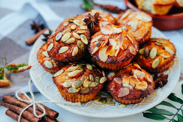 Healthy fall vegetarian dessert. Apple cupcake with pumpkin, almond seeds and spices.