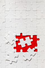 Unfinished white jigsaw puzzle pieces. Fill in pieces of the jigsaw puzzle. Complete the jigsaw...