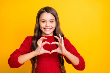 Portrait of positive cheerful child make heart figure from her fingers lovers sign wear stylish...