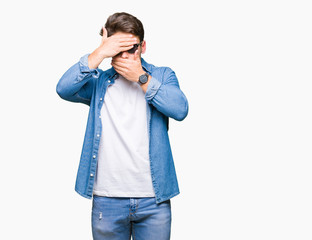 Young handsome man wearing sunglasses over isolated background Covering eyes and mouth with hands, surprised and shocked. Hiding emotion