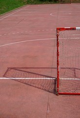 Fototapeta premium soccer goal in the empty red field on the street