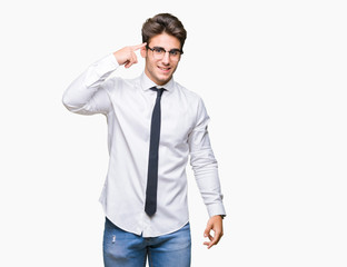 Young business man wearing glasses over isolated background Smiling pointing to head with one finger, great idea or thought, good memory