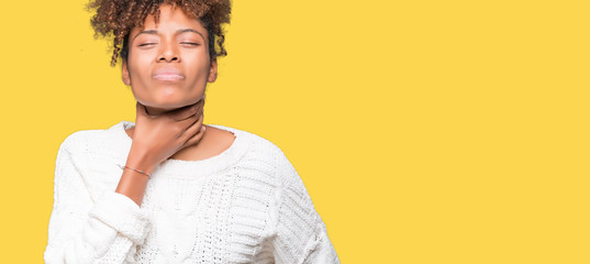 Beautiful young african american woman wearing winter sweater over isolated background Touching painful neck, sore throat for flu, clod and infection