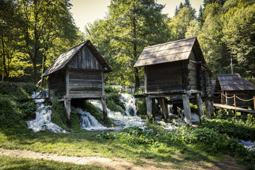 Old small wooden water mills called Mlincici by the Pliva lakes near the Jajce town in Bosnia and Herzegovina