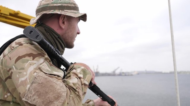 Guard on board of vessel patrols port zone
