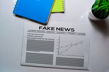 Fake News text in headline isolated on white background. Newspaper concept