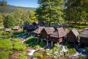Old small wooden water mills called Mlincici by the Pliva lakes near the Jajce town in Bosnia and Herzegovina