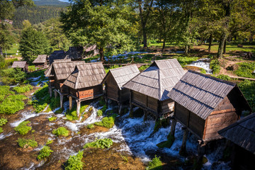 Old small wooden water mills called Mlincici by the Pliva lakes near the Jajce town in Bosnia and Herzegovina