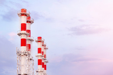 many white with red pipes new boiler room on the background of blue sky. Pipe with running steam...