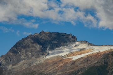 A high mountain where there is snow in the clouds