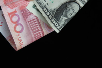 dollar and yuan on a black background with space for test
