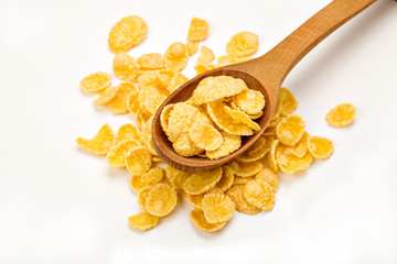 handful of cornflakes in a wooden spoon