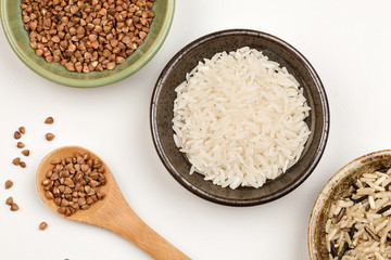 white rice, buckwheat and brown rice in plates