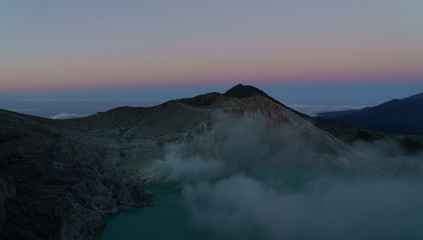 First light with fog. Sunrise on on the mountain  Ijen  Java ,Indonesia.