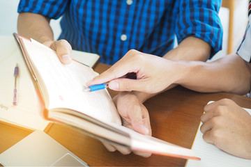 High school or college students are studying and reading together.  Share the knowledge and explain before the exam.