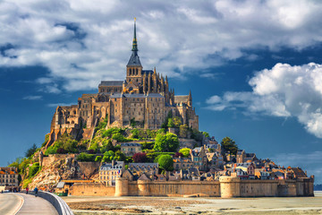 Beautiful panoramic view of famous Le Mont Saint-Michel tidal island with blue sky. Normandy, northern France - obrazy, fototapety, plakaty