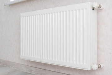Individual heating radiator on a wall at an apartment.