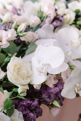 The wedding table of the newlyweds is decorated with fresh white roses and orchids