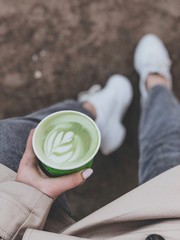 young woman drinking coffee in the garden