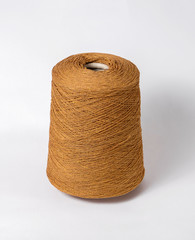bobbin of yarn on a white background. Side view.Textile reel on isolated white background.