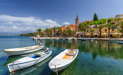 Fototapeta na wymiar Fishing boats in Splitska village with beautiful port, Brac island, Croatia. Village of Splitska on Brac island seafront view, Dalmatia, Croatia, Croatia.