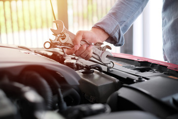 A man fixing the car engine with copy space.