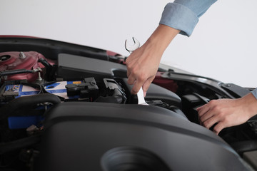 A man fixing the car engine with copy space.