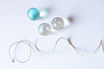 Illuminated marbles along with a string over white