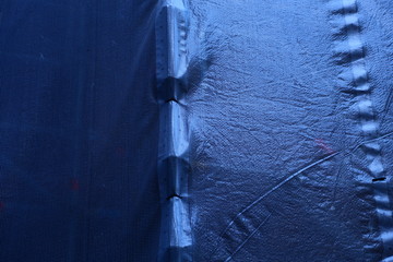 Construction work on old brick house with scaffolding, tarps, cement etc