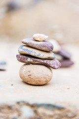 Fototapeta na wymiar Balance of rocks. Overlap of little stone with blur background.