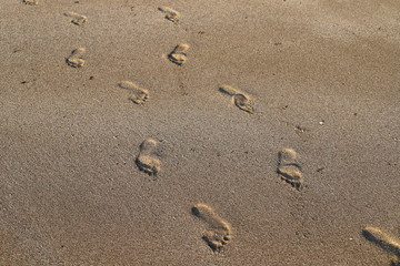 footprints in the sand on the shores of the Mediterranean Sea in the north of Israel