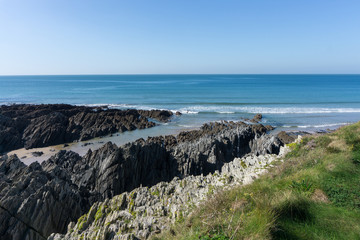 Rugged rocky coastline at Barricane beach in Woolacombe , Devon