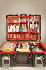 Suitcase of criminologist technician with many tools of evidence collecting