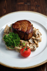 Meat medallion with mushrooms. restaurant menu
