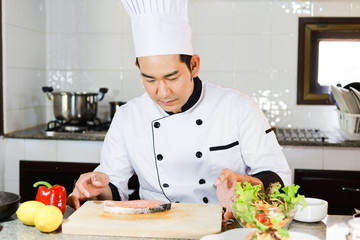 Asian Man Chef cooking food  in restuarant
