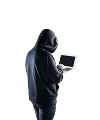 Rear view of young hacker using laptop
