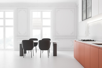 Comfortable white and orange kitchen with table