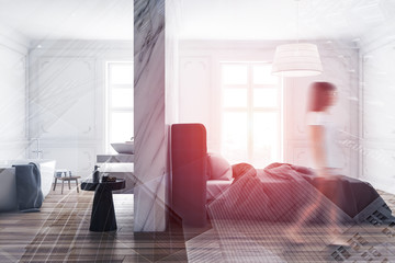 Woman walking in master bedroom with bathroom